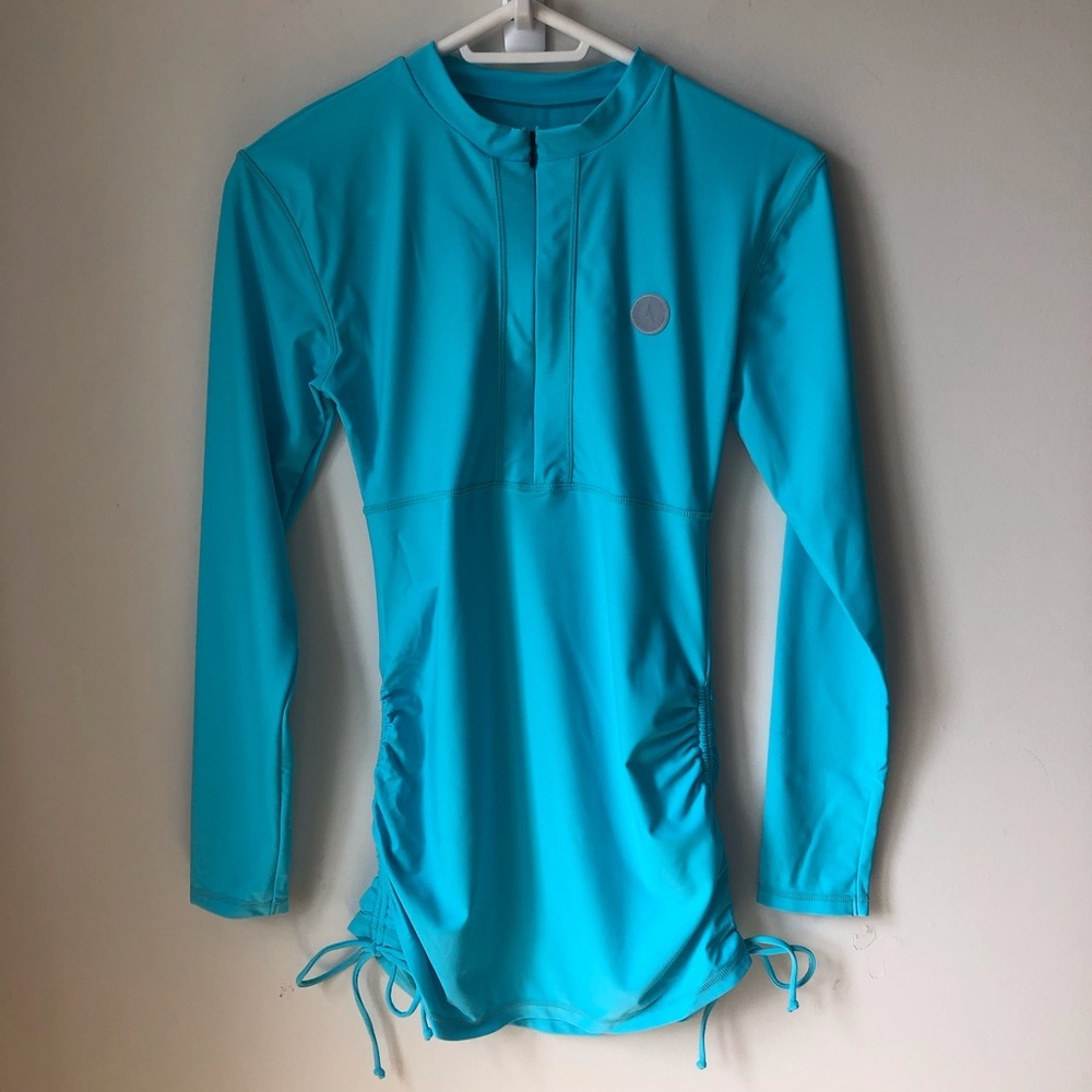Turquoise Long Sleeve Rash Guard half zip cinches at sides. UV protection